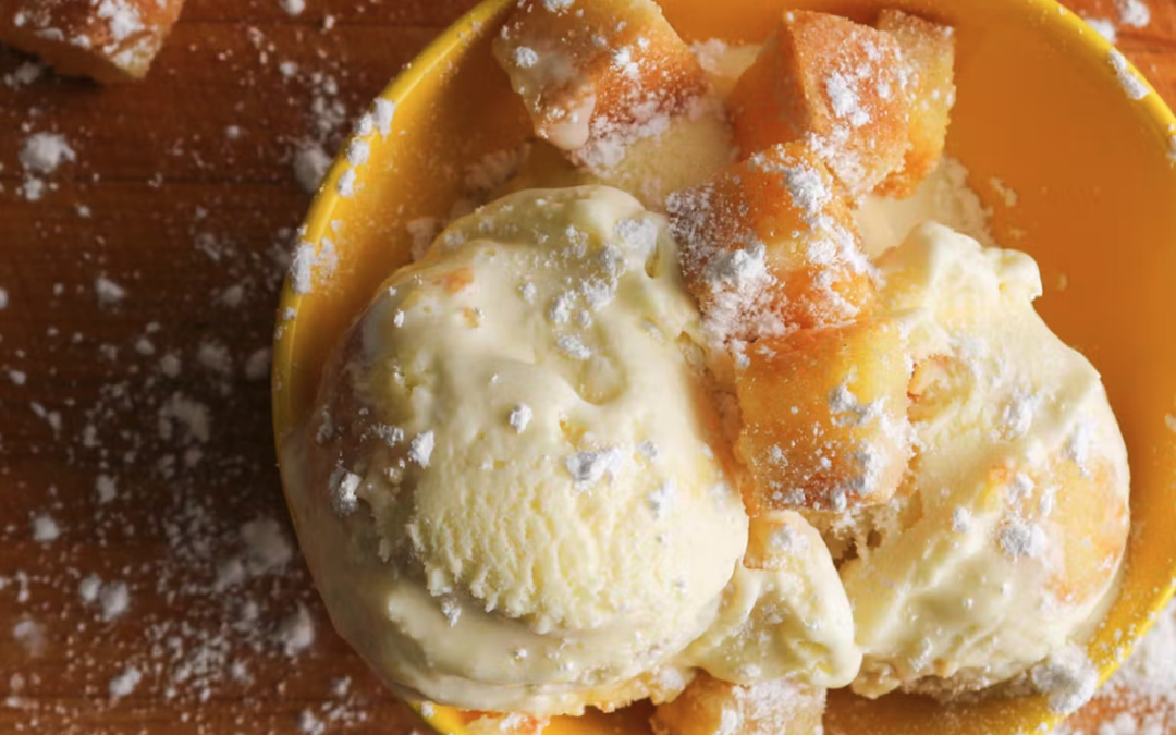 A bowl of ice cream from Clementine's Naughty and Nice Ice Cream with caramel and powdered sugar